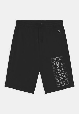 Shorts noirs en mélange de coton avec une taille élastique, un cordon de serrage et un imprimé graphique "Calvin Klein" en argent sur le côté.