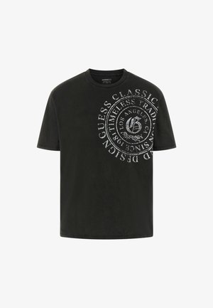 Tricou negru din bumbac, cu un grafic circular alb mare cu text și logo în față. Guler clasic rotund și mâneci scurte.