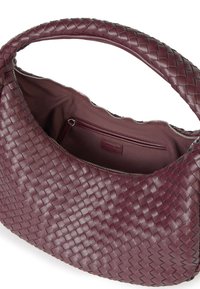 Bolso de cuero burdeos tejido con una forma sobredimensionada, cuenta con un asa trenzada, cierre de cremallera y un bolsillo interior para almacenamiento.