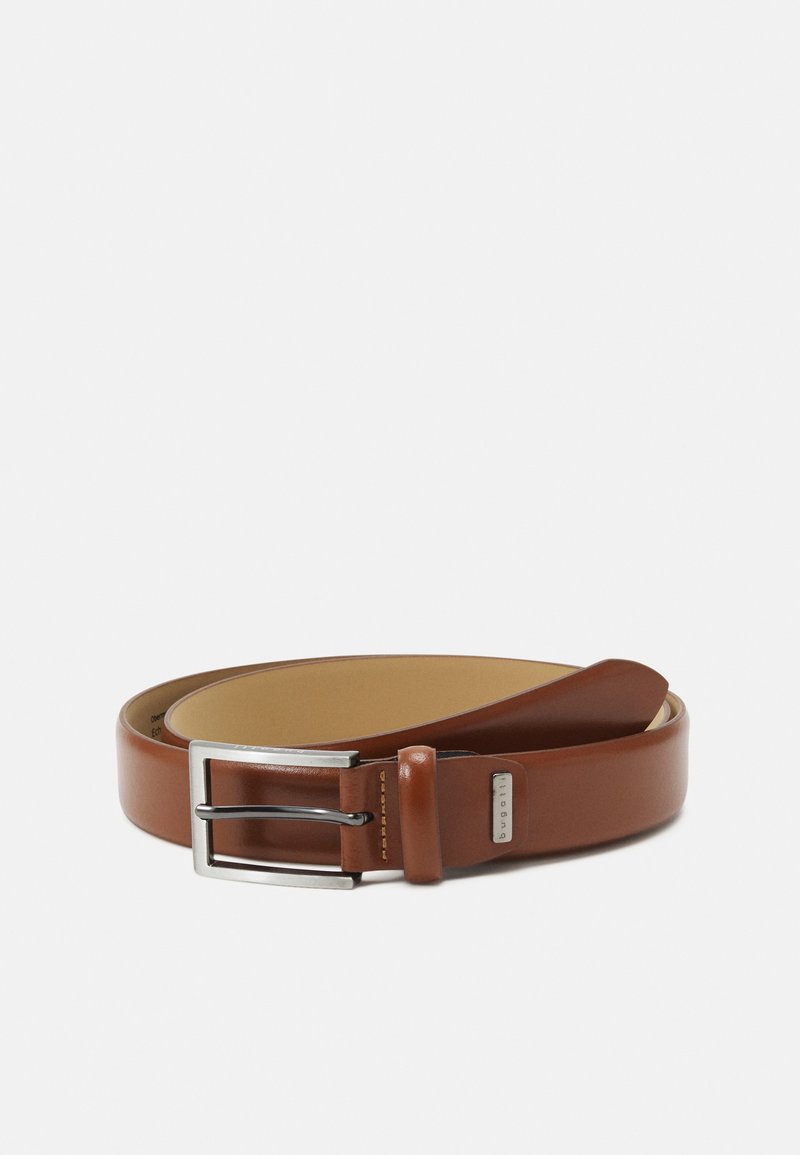 Bruine leren riem met een gladde afwerking, zilveren metalen gesp en één lus. Heeft een contrasterende binnenkleur.