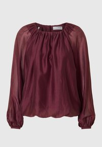 Viininpunainen pusero pyöreällä kaula-aukolla, pitkillä pömppöhihnoilla ja kerätysti laskostettu yläosa. Valmistettu kevyestä, puoliläpinäkyvästä kankaasta, jossa on sileä pinta.