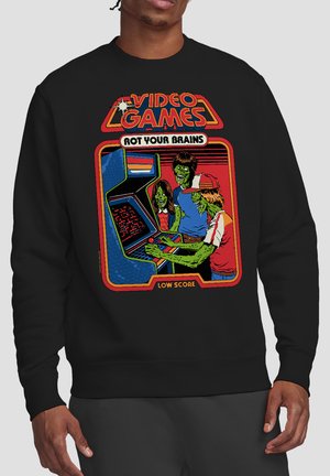 Drei grüne Zombiefiguren spielen ein Arcade-Spiel, darüber steht der Text „Videospiele verfaulen dein Gehirn“ und darunter „Niedriger Punktestand“.