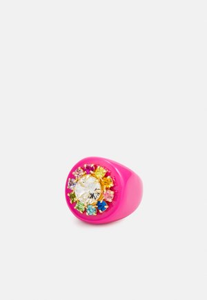 Bright pink ring with a large clear gemstone center, surrounded by smaller multicolored gemstones set in gold prongs.