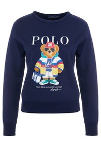 Felpa blu navy con un grafico colorato di un orso che indossa una giacca, occhiali da sole e cappello. Testo "POLO" in grassetto sopra il design. Materiale in misto cotone.