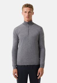 Grauer Reißverschluss-Pullover mit langen Ärmeln, aus einem weichen Material gefertigt. Verfügt über einen hohen Kragen und ein tailliertes Design. Die Bündchen und der Saum sind gerippt.