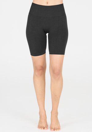 Shorts de vélo noirs en tissu extensible, dotés d'une taille haute, d'une coupe ajustée et d'une texture douce, s'étendant jusqu'à mi-cuisse.
