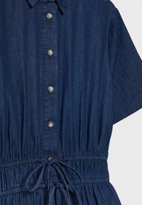 Denim dress in deep blue with a collared neckline, short sleeves, button front, and an elasticized waist with a drawstring detail.