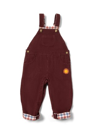Burgunderfarbene Corduroy-Latzhose mit verstellbaren Trägern, Fronttasche und umgeschlagenen Beinen, die ein Schachbrettmuster und eine gelbe Sonnenverzierung aufweisen.