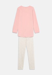 Pink long-sleeve top with a round neck paired with white pajama pants featuring a small floral pattern in pink, blue, and yellow.