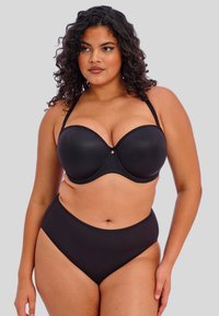 Soutien-gorge noir rembourré avec armatures et bretelles réglables, associé à un slip taille haute. Texture lisse, design minimaliste, sans motifs.