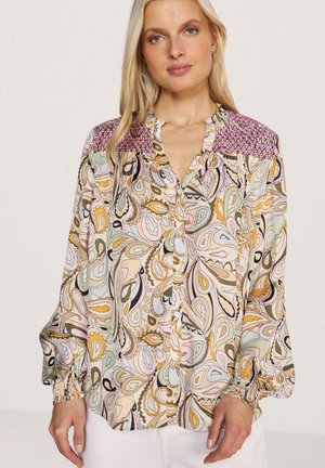 Long-sleeve blouse in lightweight fabric featuring a colorful paisley pattern, button closure, and smocked shoulders with a pink accent.