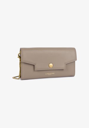 Beige leather clutch with a snap closure, gold-toned chain strap, and embossed logo. Smooth texture and minimalistic design.