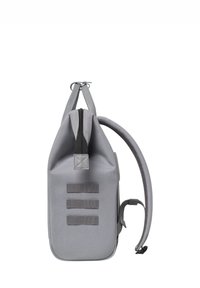 Gray backpack with a structured shape, made of durable fabric. It features a top zipper, adjustable shoulder straps, and three vertical webbing accents.