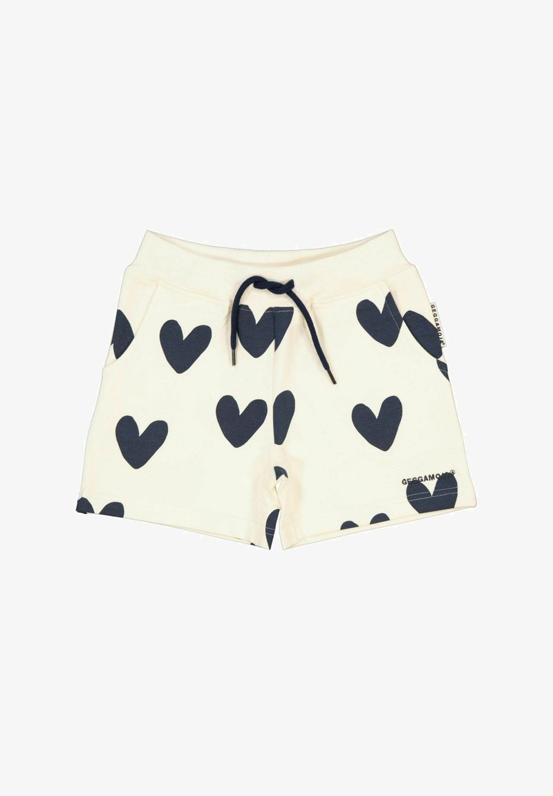 Puuvillashortsit, joissa on kerma-tausta ja laivaston sininen sydänkuvio, vetoketjulla varustettu vyötärö ja sivutaskut. Merkkilogo helman kohdalla.