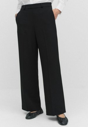 Black wide-leg trousers with a smooth texture, flat front, and belt loops. Paired with black flat shoes on a neutral background.