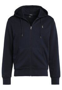 Marinblå zip-up hoodie tillverkad av bomullsblandat tyg, med känguruficka, dragsko i huven och broderad logotyp på bröstet.