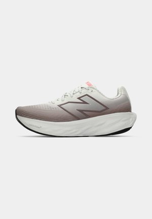 White and light brown New Balance running shoe with thick cushioned sole and "N" logo on side, shown in left profile on white background.