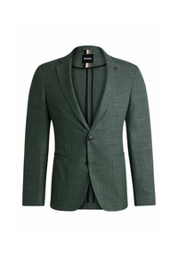 Blazer verde strutturato con rever a contrasto, due tasche frontali e chiusura a un bottone. L'interno presenta strisce verticali a contrasto.