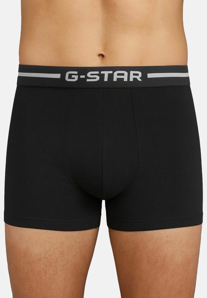 Boxer-briefs noirs avec un élastique gris comportant le logo "G-STAR". Fabriqués en tissu lisse avec un design ajusté et des coutures plates.