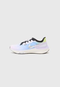 Light blue athletic shoe with a gradient effect, black laces, silver swoosh logo, pale purple accents, and a textured mesh upper.