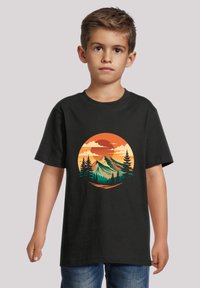 Black cotton T-shirt featuring a circular graphic of mountains, trees, and a sunset in orange and green, with short sleeves and a crew neck.