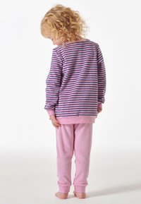 Striped purple and pink pajama top with long sleeves and a pink, soft, fleece pant. The outfit features a relaxed fit and ribbed cuffs.
