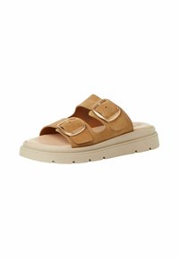 Tan suede slide sandal with two adjustable straps and gold buckles, featuring a chunky cream sole and open toe design.
