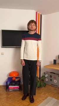 Long-sleeve shirt with navy top and maroon stripe, white body. Paired with dark jeans and dark shoes. Accessories: wristwatch, tattoos.