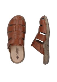 Brown leather sandals with cutout design, adjustable strap, cushioned insole, and textured rubber sole for grip and comfort.