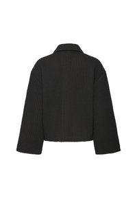 Veste noire matelassée avec des coutures verticales, des manches larges, une coupe carrée et un col simple, vue de dos sur un fond blanc.
