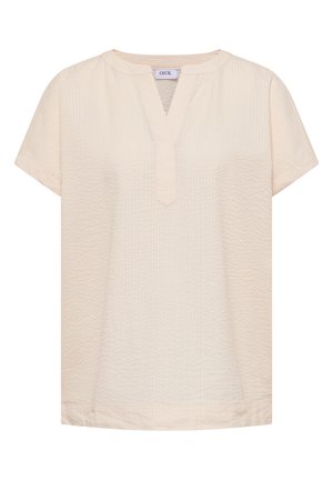 Krémová krátká halenka s texturou s výstřihem do V a kulatým límečkem, označená "Cecil" na výstřihu.