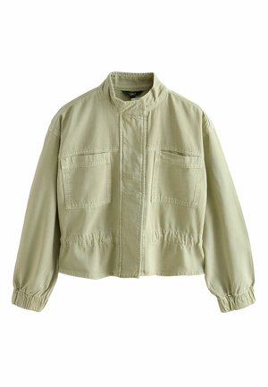 Világoszöld dzseki álló gallérral, elöl cipzárral, amelyet textil fedlap takar, két mellzsebbel, elasztikus mandzsettákkal és deréknál húzott szabással.