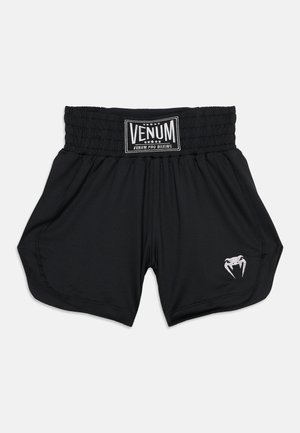 Short de boxe Venum Pro noir avec large ceinture élastique et logo de croc de serpent blanc sur la jambe inférieure droite.