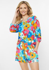Farverig blomstertryk romper i turkis, med lange pufærmer, V-udskæring, snoreliv og sidelommer.