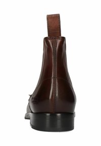 Bottes chevilles en cuir marron avec une texture lisse, dotées d'une languette à l'arrière et d'un talon bas empilé. Logo notable en relief sur le côté.