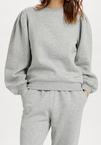 Gray sweatshirt made of soft fabric, featuring puffed sleeves and a ribbed hem. The cuffs are also ribbed, providing a comfortable fit.