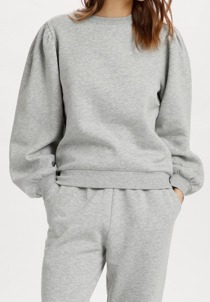 Gray sweatshirt made of soft fabric, featuring puffed sleeves and a ribbed hem. The cuffs are also ribbed, providing a comfortable fit.