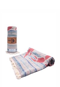 Multicolored woven throw blanket in blue, red, and cream. Features fringe edges and abstract patterns. Rolled and displayed partially flat.