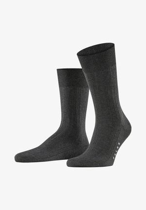 Dunkelgraue, gerippte Socken aus weichem Material, mit einem strukturierten Muster und einem kontrastierenden gestrickten Bund, sowie einem weißen Logo im Zehenbereich.