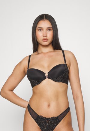 Black lingerie set featuring a smooth satin bra with lace accents and a central clasp, paired with sheer lace-trimmed panties.