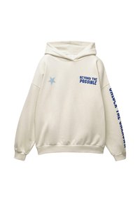 Cremfarbener Hoodie mit blauer Sternapplikation auf der Brust, dem Text "BEYOND THE POSSIBLE" auf der Vorderseite rechts und dem Text "UNLOCK THE UNKNOWN" entlang des linken Ärmels.