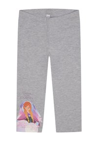 Leggings grises fabricados con tejido suave, que presentan un diseño impreso colorido de un personaje y el texto "Cree en el Viaje" en una pierna.