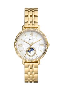 Montre Fossil avec un bracelet en métal doré, un cadran rond en nacre blanche, des accents en cristal et un indicateur de phase lunaire en bas.