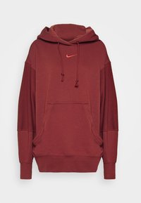 Sudadera burdeos con bolsillo frontal, capucha con cordón y logotipo de Nike rojo en el pecho. Tejido suave, corte relajado y mangas largas.