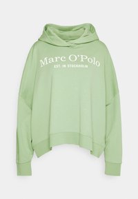 Sudadera holgada de color verde claro hecha de una tela suave. Presenta una capucha con cordón y texto blanco que dice "Marc O'Polo EST. EN ESTOCOLMO."
