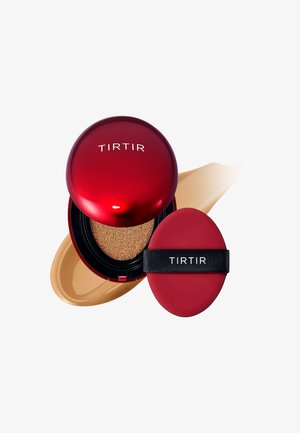 Red circular compact with a glossy finish, containing a sponge applicator and a honey-colored foundation. Features embossed logo on top.