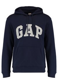 Felpa blu navy realizzata in tessuto morbido, con una grande stampa grigia "GAP" sul davanti, una tasca a marsupio e polsini e orlo a coste.