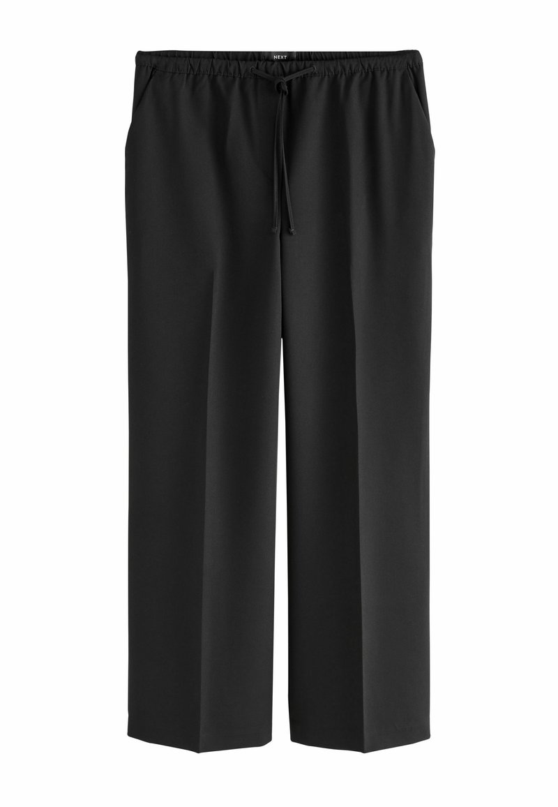 Schwarze weit geschnittene Hose aus weichem Stoff, mit einem elastischen Bund und Zugband, sowie Seitentaschen für Funktionalität.