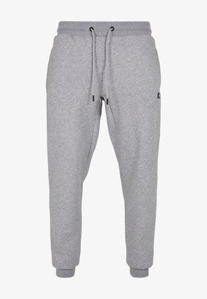 Pantalones de chándal grises hechos de tela suave, con una cintura elástica con cordones, bolsillos laterales y puños acanalados en los tobillos.