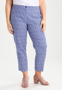 Blue patterned capri pants with intricate white designs, featuring a button closure and a smooth fabric texture.